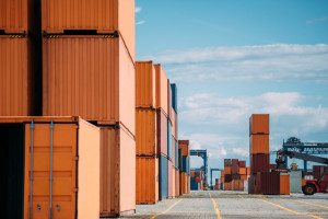 Shipping containers standing in a port.