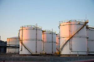 Oil tanks standing under a bright sky.