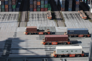 Trucks and containers standing near a loading dock.
